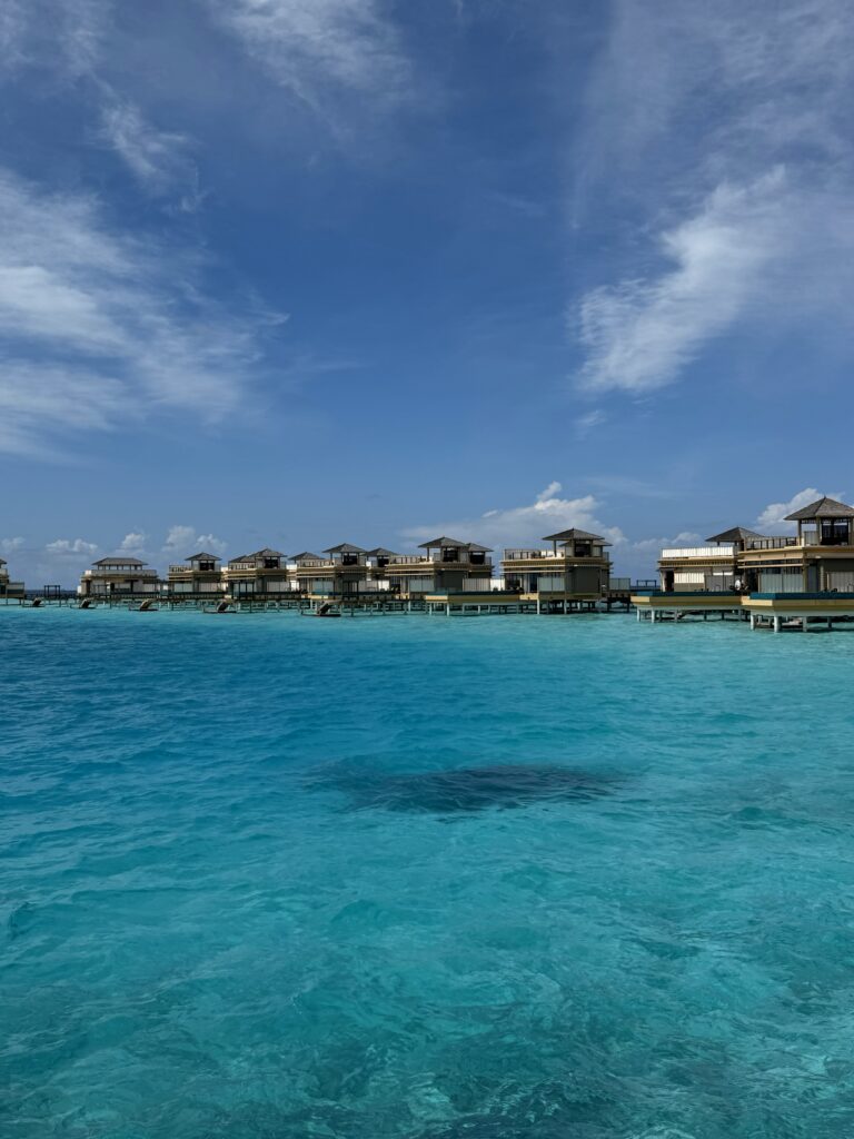 Overwater bungalows in the Maldives above crystal-clear turquoise water
