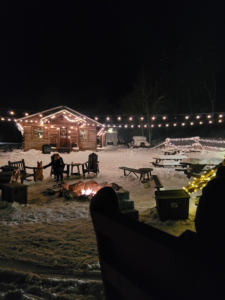 Cozy cabin and outdoor fire pit during a winter sleigh ride dinner