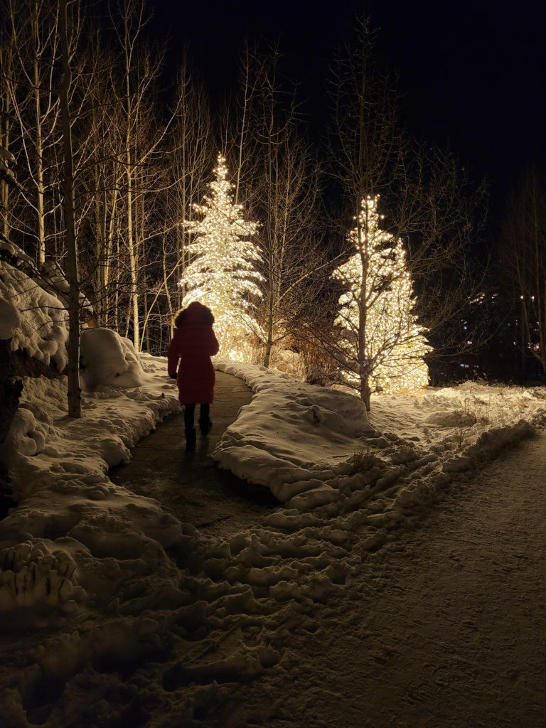 Vail Colorado in December with snow-covered trees and Christmas lights
